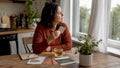 Woman contemplating nicotine patch at kitchen table