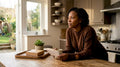 Woman holding quit date note at kitchen table