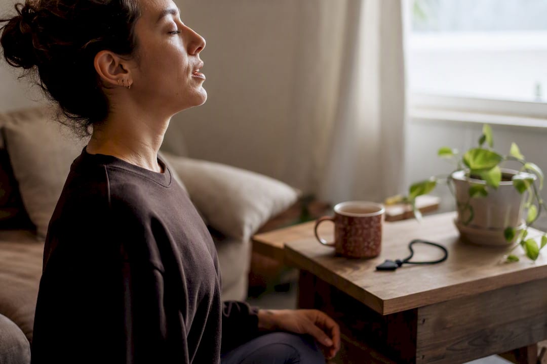 Person performing calming breathing exercise