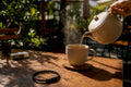 Coffee pouring with nicotine resistance necklace nearby