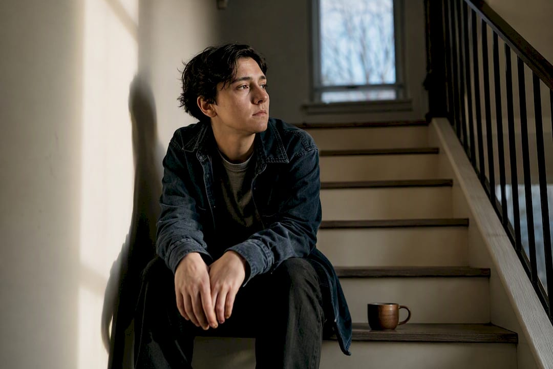 Person sitting through early withdrawal mood crash