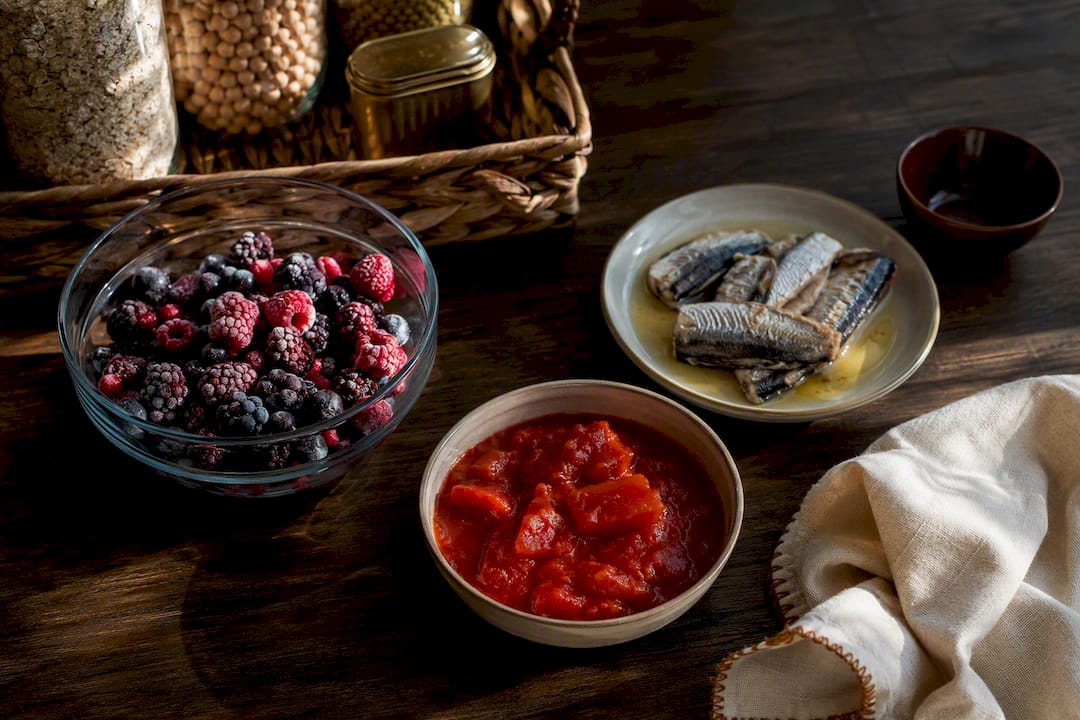 Berries tomatoes and oily fish arranged together
