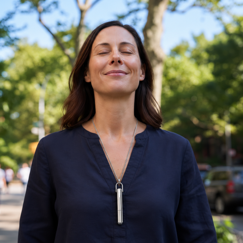 A woman taking a calm deep breath outdoors